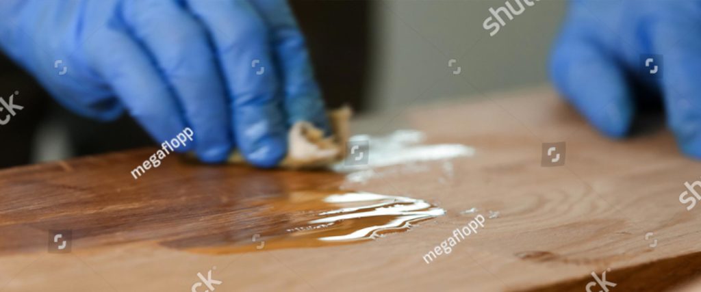 stock photo close up of woodworker hands in protective gloves covering wooden surface joiner lacquering part